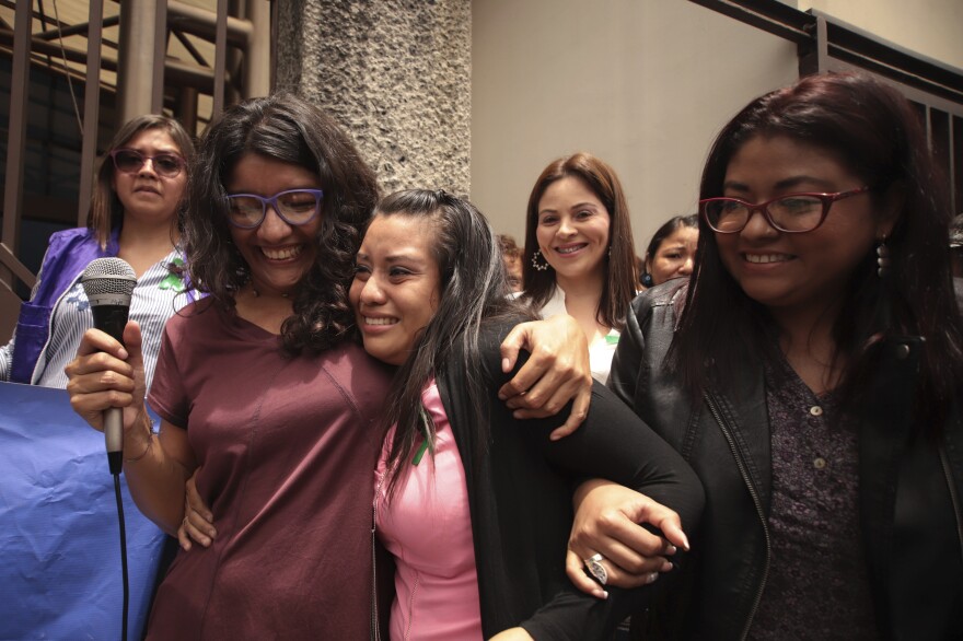 Evelyn Hernández (center) is embraced by supporters after she was acquitted of aggravated homicide in her retrial related to the loss of a pregnancy.