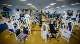 People using fitness machines in a gym