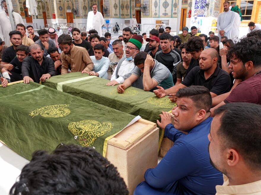 Iraqis mourn relatives killed during a fire in a hospital in the capital, during a funeral procession in the holy shrine city of Najaf, on April 25, 2021. - The fire which erupted pre-dawn at the Ibn Al-Khatib Hospital in Baghdad, a medical facility reserved for the most severe COVID-19 cases, killed 82 people, sparking angry calls for officials to be sacked in a country with long-dilapidated health infrastructure. (Photo by Ali NAJAFI / AFP) (Photo by ALI NAJAFI/AFP via Getty Images)
