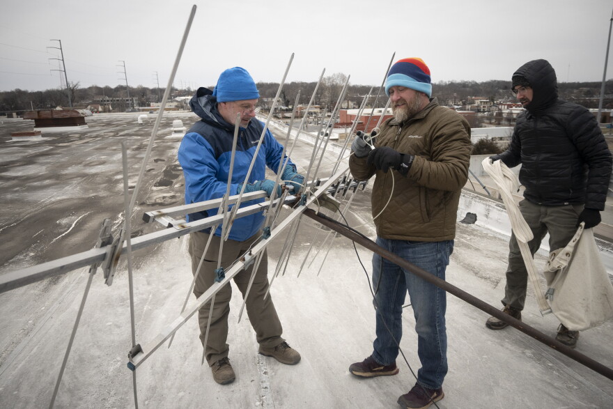 Claus and KCUR Director of Broadcast Operations, Chris Prewitt, dismantling an antenna during a snowstorm on the rooftop of KCUR's former home, 4825 Troost.