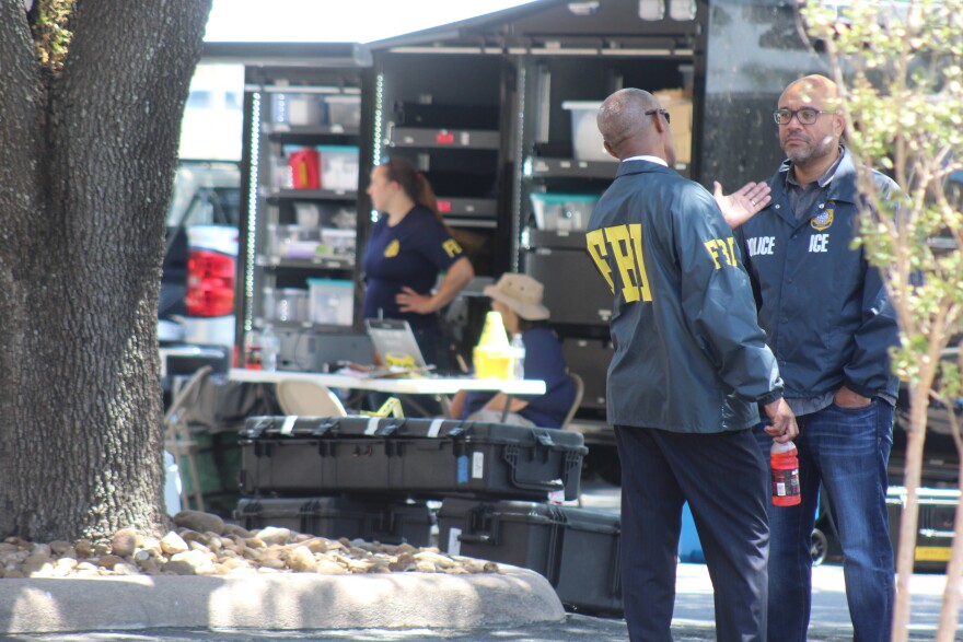FBI and ICE officials speak outside of the Immigration Enforcement and Removal Operations office.