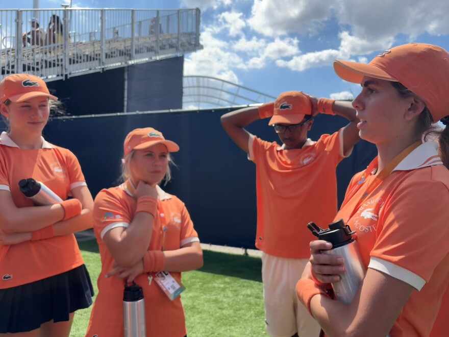 Ballperson Captain Guadalupe Merlino (far right), 17, leads a debrief with her team after a match between Victoria Mboko and Mirra Andreeva at the 2026 Miami Open on March 23 at Hard Rock Stadium in Miami Gardens.