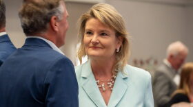 Cindy Holscher, the Democratic nominee for Kansas governor, points to differences on healthcare, public schools and other issues illustrate the distinctions between her and Republican nominee Ty Masterson. This image from Aug. 27,2026, is of Holscher campaigning in Olathe.