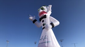 A hot air balloon in the shape of the iconic effigy Zozobra inflates in Santa Fe