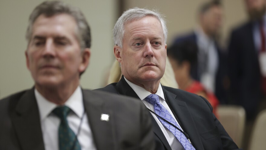 Former White House chief of staff Mark Meadows, right, and former Republican Sen. Jim DeMint, left, attend a summit organized by the America First Policy Institute on July 25, 2022. Meadows and DeMint have both been involved with the Conservative Partnership Institute, a nonprofit raising concerns among tax experts.