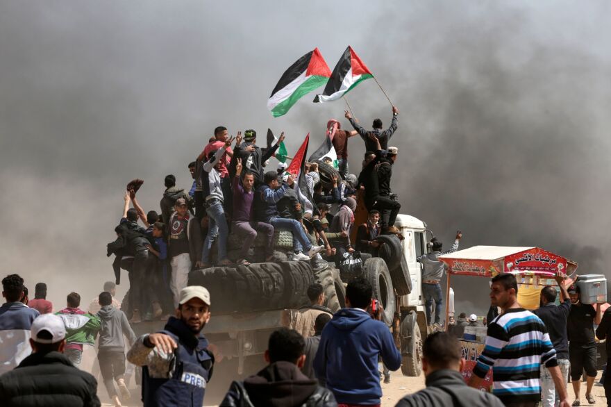 Palestinian demonstrators burned tires in order to create a smoke screen to block the view of Israel forces.