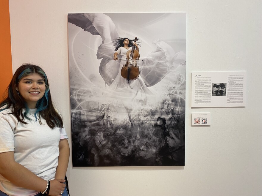 Valeria Gonzalez with her portrait as part of the See Me Because exhibition at Walker's Point Center for the Arts.