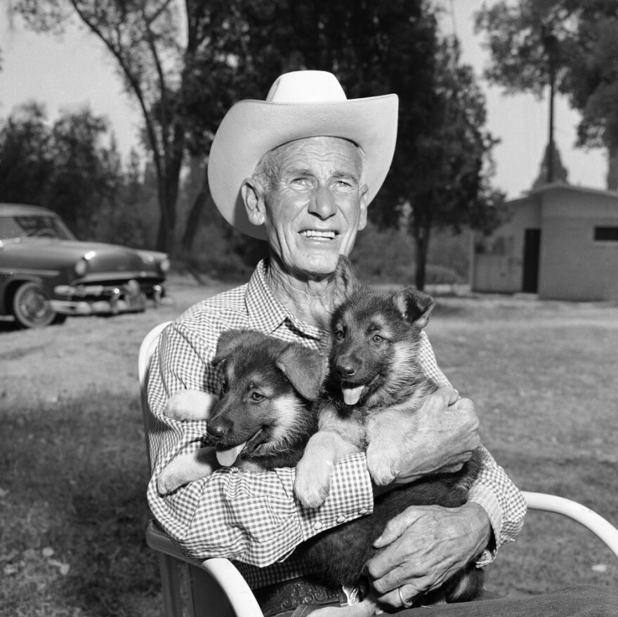 Lee Duncan, 67, holds a pair of Rin Tin Tin's descendants, Rin Tin Tin 5 and 6, in 1958.