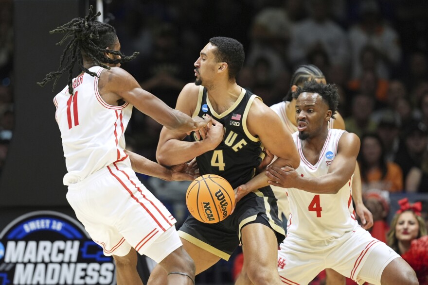 Purdue's Fletcher Loyer, right, looks to pass around Houston's Emanuel Sharp (21) during the first half in the Sweet 16 of the NCAA college basketball tournament Friday, March 28, 2025, in Indianapolis.