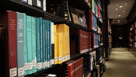 Rows of historical books on display at a library. 