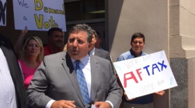 Hamilton County Republican Party Chairman Alex Triantafilou with sales tax repeal petitions. Behind him are GOP volunteers urging people to vote down the "Aftax," a reference to Democratic Clerk of Courts Aftab Pureval. 
