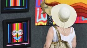 Viewer looks at art at Downtown Venice Art Classic.