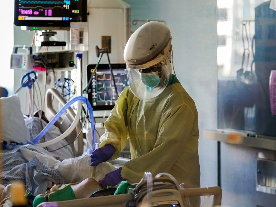 FILE - In this Wednesday, Jan. 13, 2021, file photo, a healthcare worker tends to a COVID-19 patient in an intensive care unit during the coronavirus pandemic in San Jose, Calif.