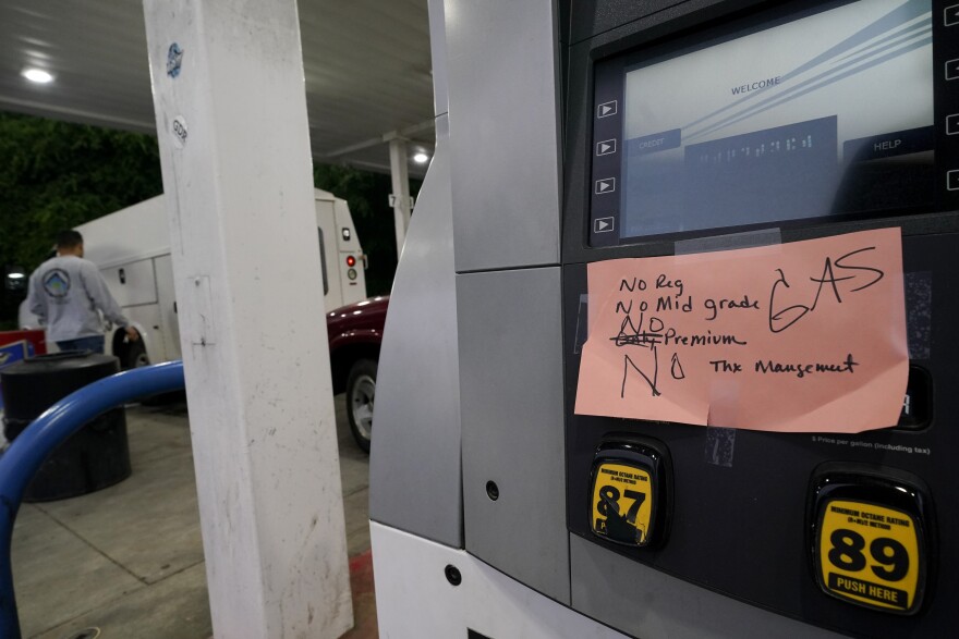 A hand-written sign is posted on a gas pump, showing that the service station is out of all grades of fuel Wednesday, May 12, 2021, in Charlotte, N.C. Several gas stations in the Southeast reported running out of fuel, primarily because of what analysts say is unwarranted panic-buying among drivers, as the shutdown of a major pipeline by hackers entered its fifth day.