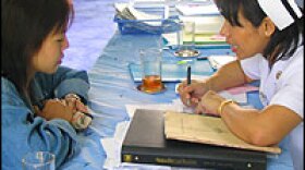 La, a 30-year-old Burmese woman living in the north of Thailand, is counseled by a nurse at Chiangsen Hospital on how to take anti-AIDS drugs. La became infected witih HIV as a teenager while working in the commercial sex industry in Bangkok.