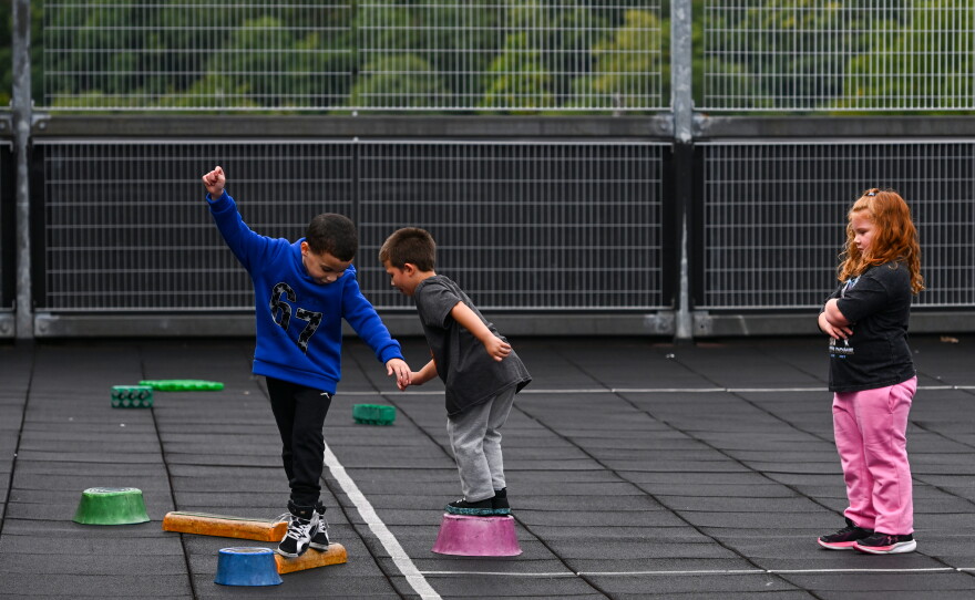 Ashlyn Murray watches her friends walk an obstacle path during recess in the Saint Clair Area School District.