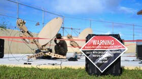 A hazard warning sign marks the area where satellite communication dishes were erected by 644th Combat Command Squadron Airmen at the Pacific Regional Training Center, Andersen Air Force Base, Aug. 9, 2024.