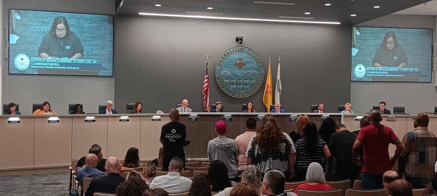 A group of Bernalillo County behavioral health employees stand as Victoria Gurule gives public comment in opposition to an ordinance that passed the County Commission on a 3-2 vote Tuesday June 25.
