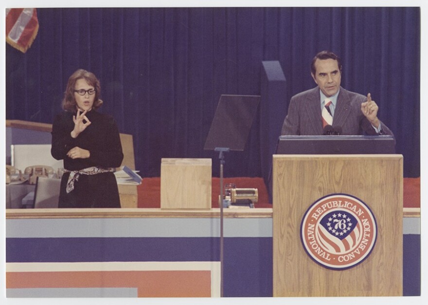 Senator Dole (right) speaking at the 1976 Republican National Convention in Kansas City, Missouri. His ASL interpreter is on the left.