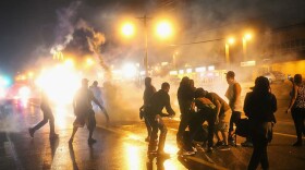 Police fire tear gas at demonstrators protesting the shooting of Michael Brown after they refused to honor the midnight curfew on August 17, 2014 in Ferguson, Missouri.  (Scott Olson/Getty Images)