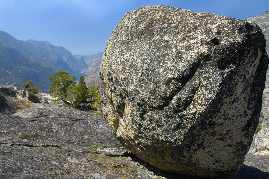 A glacial erratic with the Hetch-Hetchy Reservoir in the background.