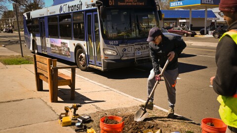 Dimitris Koutoumbas, with Connecticut Urbanists, works at a bus stop on Maple Ave and Brown St. in Hartford on April 11, 2026.