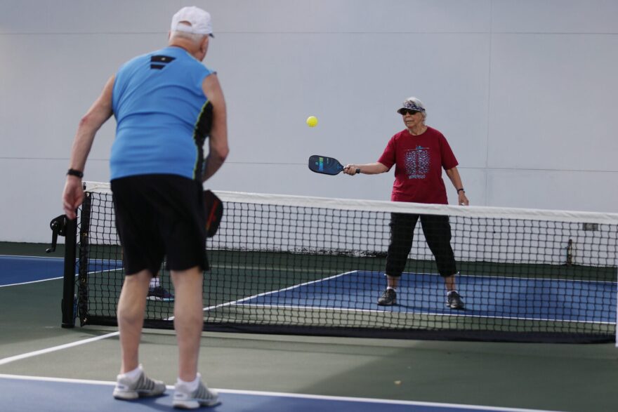 Lance Shaw and Norma Jenkins take a class in the game pickleball with a group fully vaccinated against COVID-19 at the John Knox Village Continuing Care Retirement Community in Pompano Beach, Florida.