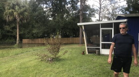 Mark Masella’s yard regularly floods after rain. One time, the water reached his porch. There is now water damage on his wooden fence as a result. (Amy Galo/WUFT News)