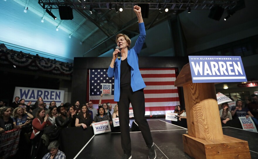 Sen. Elizabeth Warren makes a fist during a campaign event in Seattle. Washington state holds its nominating contest March 10, a week after Super Tuesday.