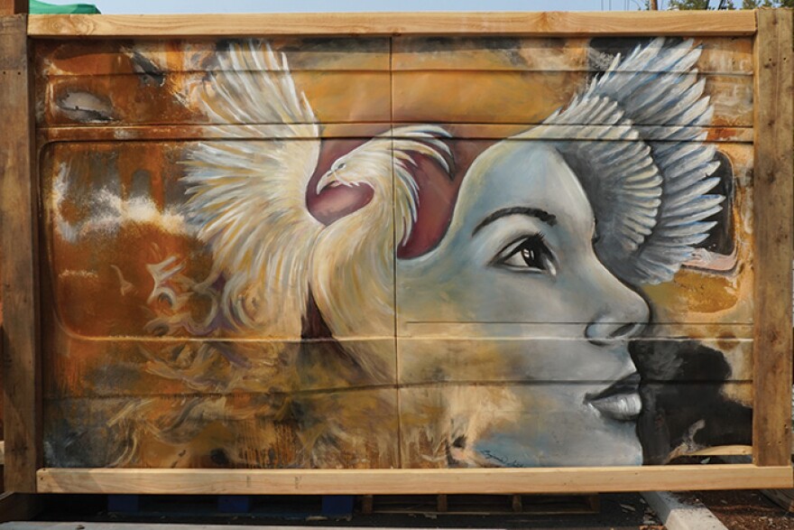 Artist Benjamin Swatez painted this “Phoenix Rising” mural on a Sprinter Van that lived at Rogue Climate’s office in Phoenix. The panel is now on display at the mutual aid station in Talent.