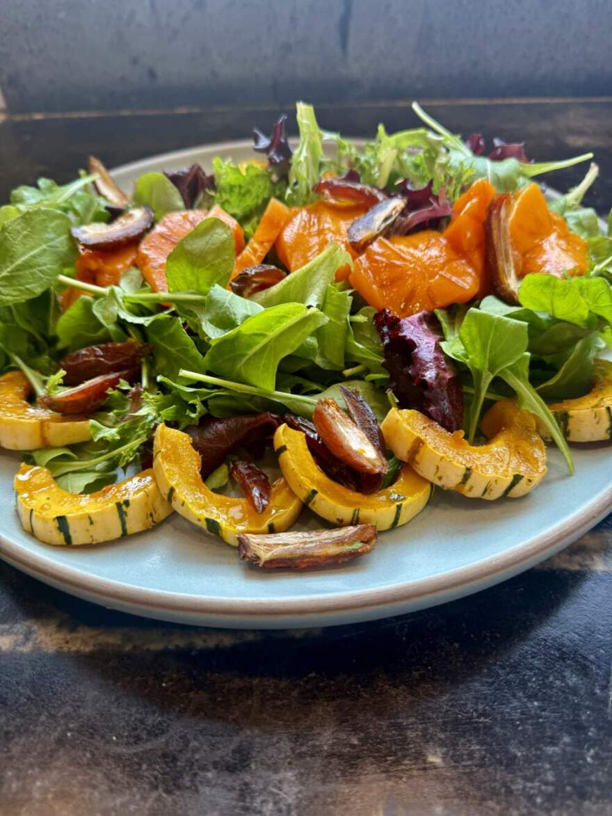 Arugula and salad greens with roasted maple squash, dates, and persimmons with a mustard-maple syrup vinaigrette. (Kathy Gunst/Here & Now)
