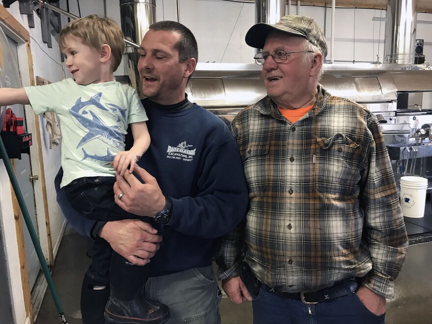 Aden, Jason and Albert Patenaude in a maple syrup processing facility.