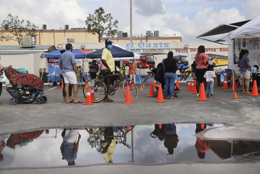 People line up to receive a rapid COVID-19 test in an agricultural community in Immokalee, Fla., where the poverty rate is over 40%. Partners in Health is working with the Coalition of Immokalee Workers to test, educate and vaccinate the community during the pandemic.