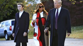 President Donald Trump and first lady Melania Trump with their son Barron Trump talk as they walk on the South Lawn of the White House in Washington, Tuesday, Nov. 20, 2018, to board the Marine One.