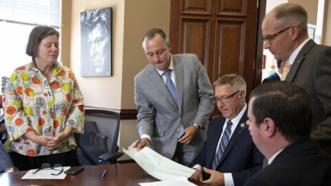 Mass. lawmakers sign paperwork on July 20, 2025 finalizing an accord on a supplemental budget bill. From left to right: Sen. Jo Comerford, Rep. Aaron Michlewitz, Sen. Michael Rodrigues, Rep. Todd Smola and Sen. Patrick O'Connor.