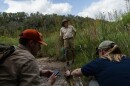 Texas Parks and Wildlife Department Natural Resources Coordinator Andy Sipocz, center, stands as Nick Boysen, left, and Kaitlyn Skinner Morris examine remains possibly belonging to a feral hog near Yancey Creek in what will become Post Oak Ridge State Park on newly acquired land near Lampasas on June 5, 2025.