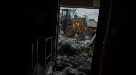 Volunteers and local workers take part in the clean up operation at the looted Bara Mall in Soweto.