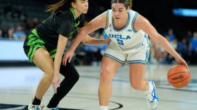 Basketball player driving toward the net