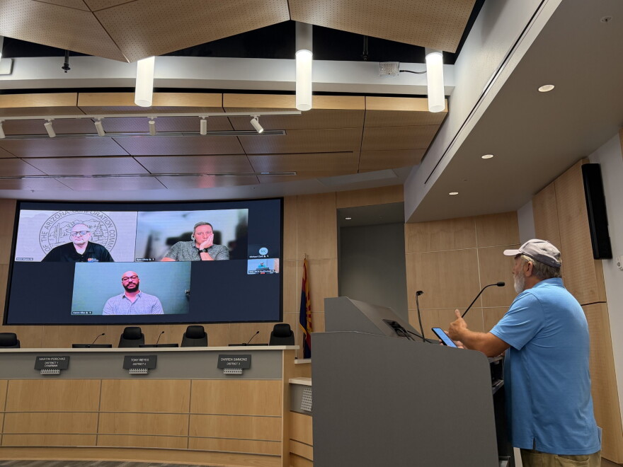 Yuma County resident Gary Skinner, right, speaks to Arizona Corporation Commission Chairman Nick Myers, upper left, at a public meeting on private water system concerns on Wednesday, Oct. 28, 2026 at the Yuma County Board of Supervisors Auditorium.