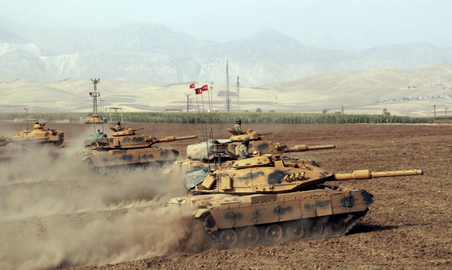 Turkish army tanks move during exercises in Silopi, near the Habur border gate with Iraq in southeastern Turkey on Monday.