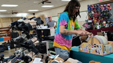Lindsey Moore processing fiber with a drum carder during Saturday’s Fiber Fest at the 4-H Center in Macomb.