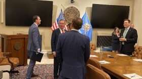 Oklahoma Gov. Kevin Stitt, left, gets ready for a meeting of the newly formed Invest in Oklahoma board at the Capitol in Oklahoma City on Tuesday, Feb. 17, 2026. Also shown are Treasurer Todd Russ and Lt. Gov. Matt Pinnell.