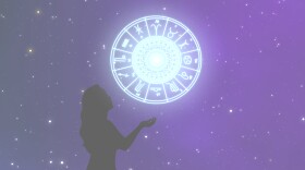 Woman lets astrology sign from her hand to the beautiful sky at night.