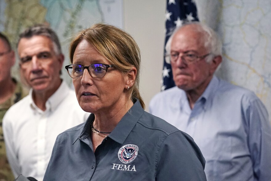 FEMA Administrator Deanne Criswell, center, addresses reporters flanked by Vermont Gov. Phil Scott, left, and U.S. Sen. Bernie Sanders, I-VT, Wednesday, July 12, 2023, in Berlin, Vt.