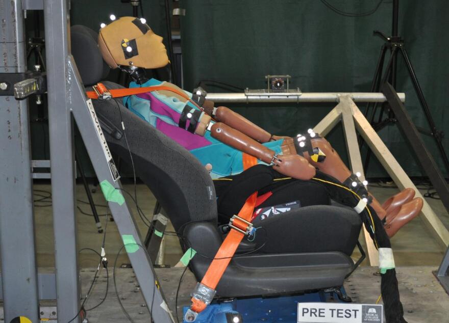 A new prototype 10-year-old crash test dummy in the crash simulator sled system in the Marquette-Medical College Wisconsin lab, testing the effects of reclined posture and potential for injury in automated vehicles.