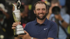 Scottie Scheffler of the United States poses for photographers with the Claret Jug trophy after winning the British Open golf championship at the Royal Portrush Golf Club, Northern Ireland, Sunday, July 20, 2025. (AP Photo/Francisco Seco)