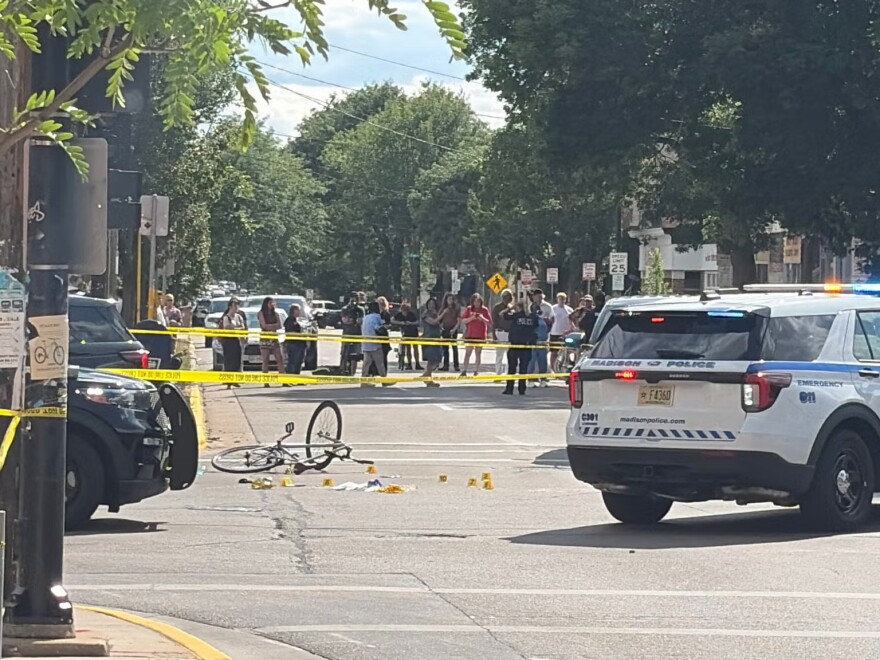 Madison Police officers block the intersection of Williamson Street and S. Baldwin Street in Madison, Wis. after police shot and killed a man on July 22, 2026.
