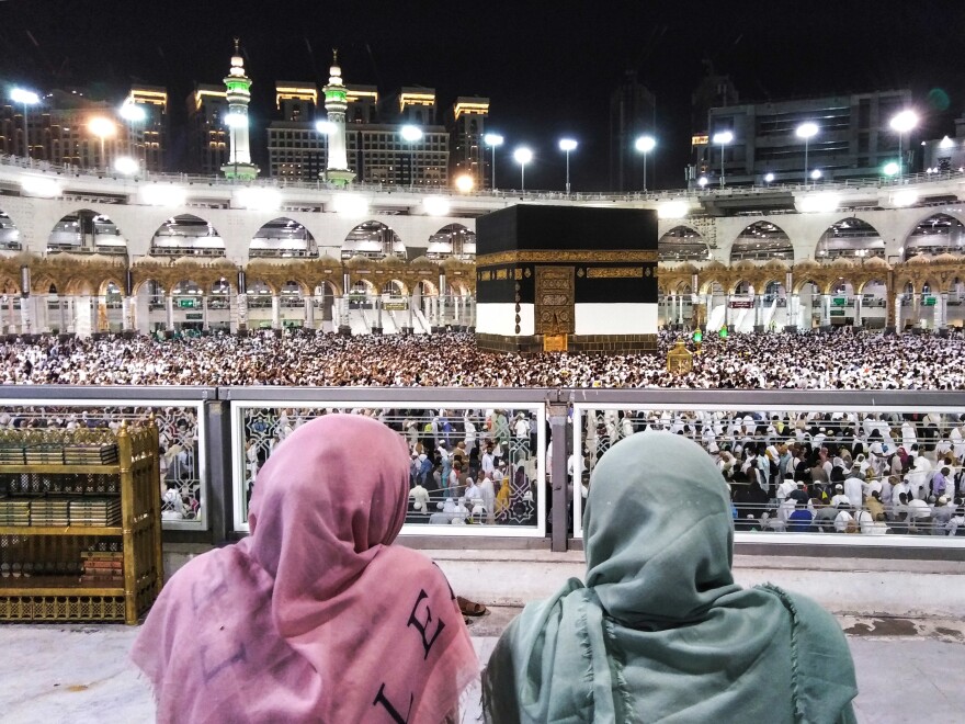 Worshipers watch as others circle the Kaaba, Islam's holiest shrine, at the Grand Mosque.