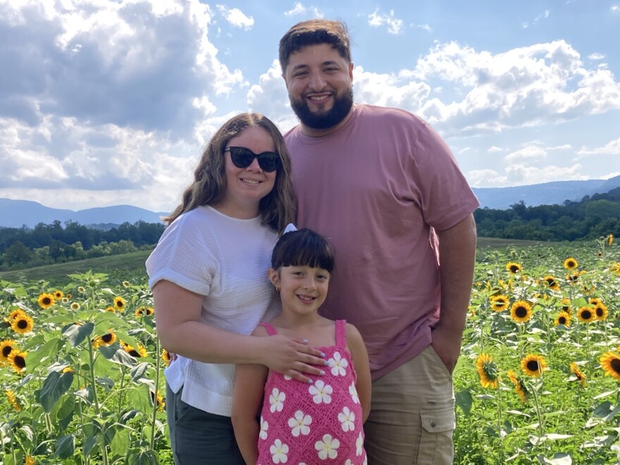 Ann Amairi joins her husband and daughter for a sunny family photo.