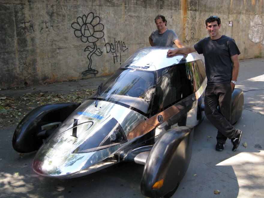 Team Edison2's Oliver Kuttner (left) and Brad Jaeger, one of the team's professional race car drivers, with the Very Light Car that won the mainstream class of the X Prize competition.